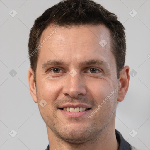 Joyful white adult male with short  brown hair and brown eyes