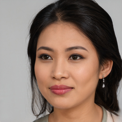 Joyful asian young-adult female with long  brown hair and brown eyes