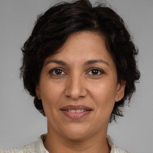 Joyful white adult female with medium  brown hair and brown eyes