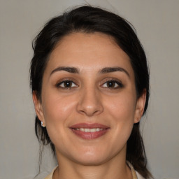 Joyful white young-adult female with medium  brown hair and brown eyes