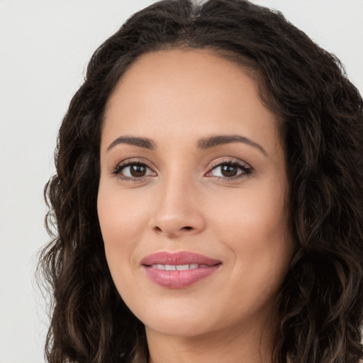 Joyful white young-adult female with long  brown hair and brown eyes