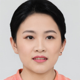 Joyful asian young-adult female with short  black hair and brown eyes