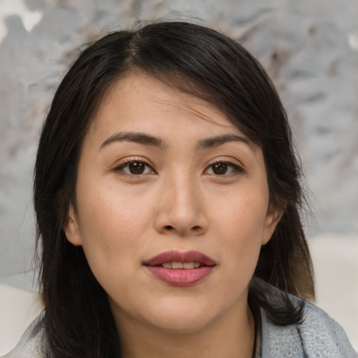 Joyful asian young-adult female with medium  brown hair and brown eyes