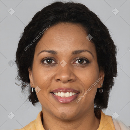 Joyful black adult female with medium  brown hair and brown eyes