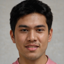 Joyful asian young-adult male with short  brown hair and brown eyes