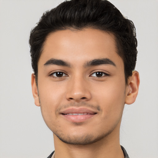 Joyful latino young-adult male with short  brown hair and brown eyes