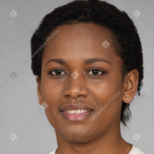 Joyful black young-adult female with short  black hair and brown eyes