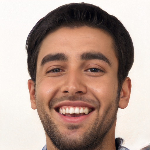 Joyful white young-adult male with short  black hair and brown eyes