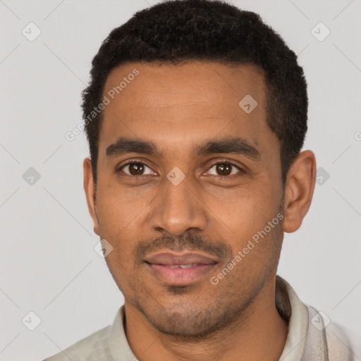 Joyful black young-adult male with short  black hair and brown eyes