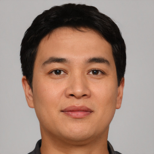 Joyful asian young-adult male with short  black hair and brown eyes