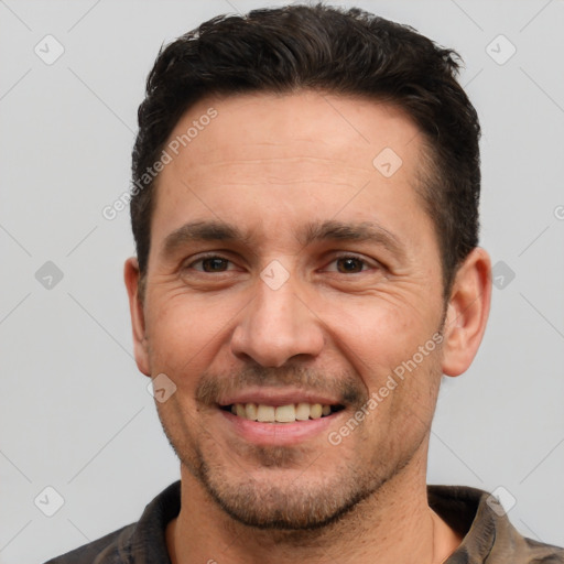 Joyful white adult male with short  brown hair and brown eyes