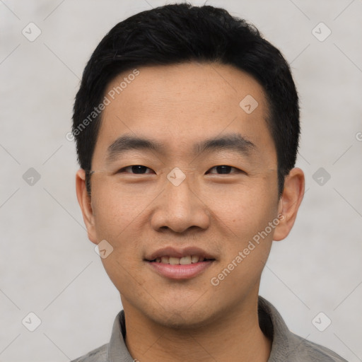 Joyful asian young-adult male with short  black hair and brown eyes