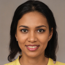 Joyful black young-adult female with medium  brown hair and brown eyes