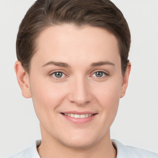 Joyful white young-adult female with short  brown hair and grey eyes