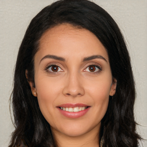 Joyful white young-adult female with long  black hair and brown eyes