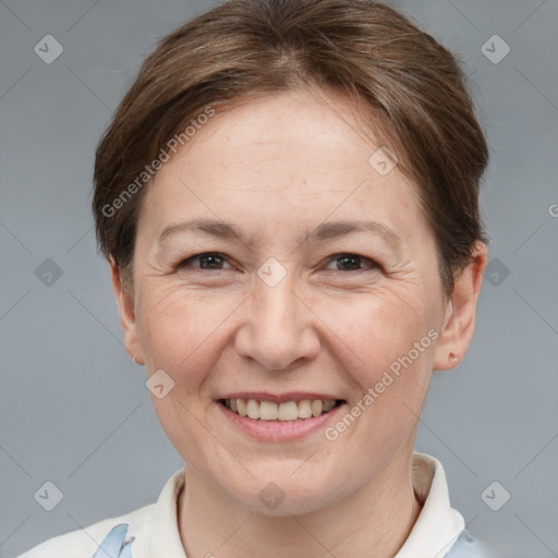 Joyful white adult female with short  brown hair and brown eyes