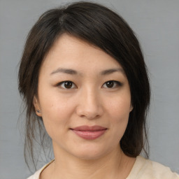 Joyful asian young-adult female with medium  brown hair and brown eyes