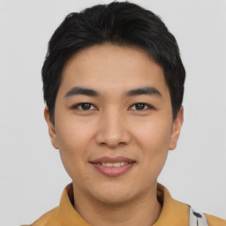 Joyful asian young-adult male with short  black hair and brown eyes