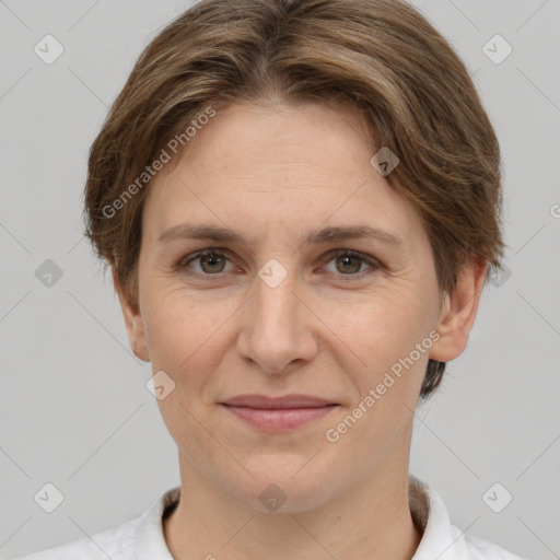 Joyful white adult female with short  brown hair and grey eyes