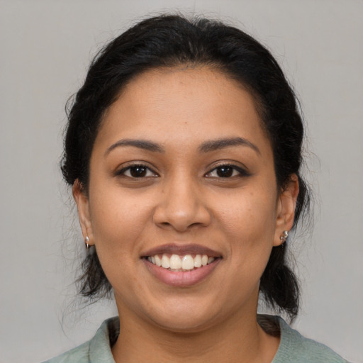 Joyful latino young-adult female with medium  brown hair and brown eyes
