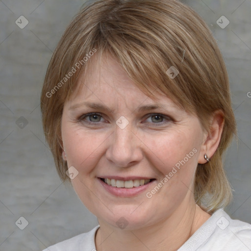 Joyful white adult female with medium  brown hair and blue eyes