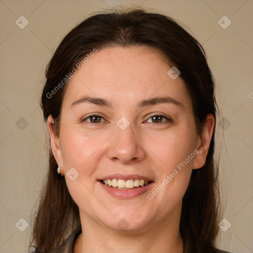 Joyful white adult female with medium  brown hair and brown eyes