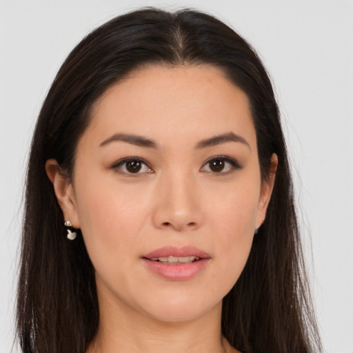 Joyful asian young-adult female with long  brown hair and brown eyes