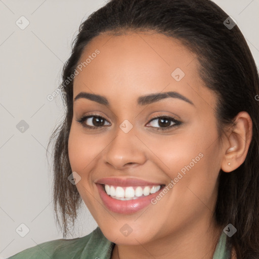 Joyful white young-adult female with long  brown hair and brown eyes