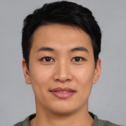 Joyful asian young-adult male with short  black hair and brown eyes