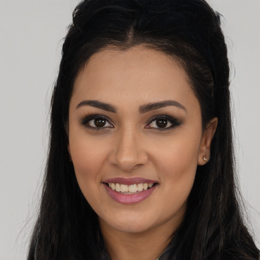 Joyful latino young-adult female with long  brown hair and brown eyes