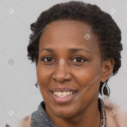 Joyful black adult female with short  brown hair and brown eyes