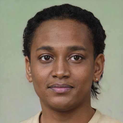 Joyful black young-adult male with short  brown hair and brown eyes