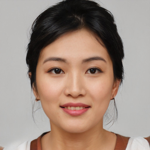 Joyful asian young-adult female with medium  black hair and brown eyes