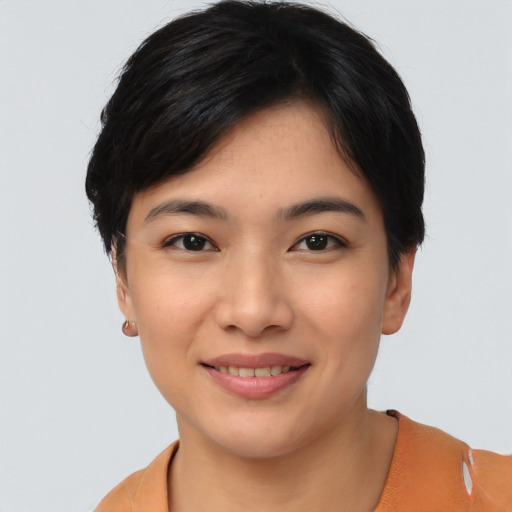 Joyful asian young-adult female with short  black hair and brown eyes