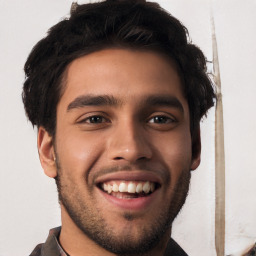 Joyful white young-adult male with short  black hair and brown eyes