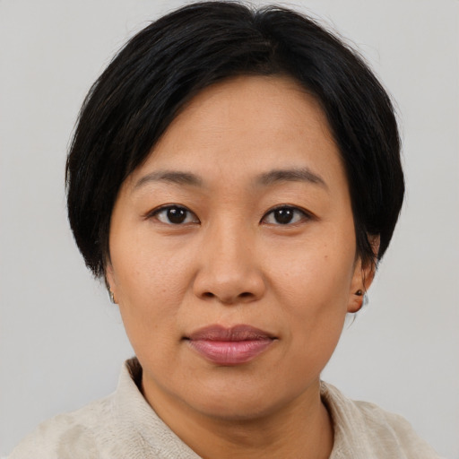 Joyful asian adult female with short  brown hair and brown eyes