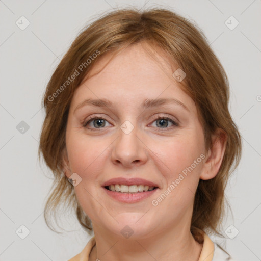 Joyful white young-adult female with medium  brown hair and blue eyes