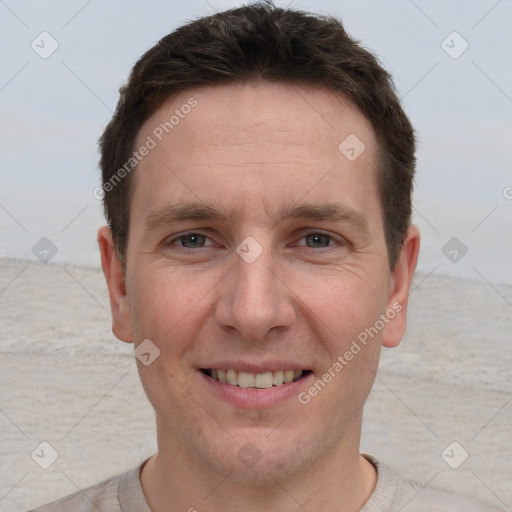 Joyful white adult male with short  brown hair and grey eyes