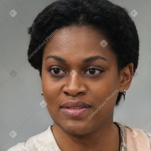 Joyful black young-adult female with short  black hair and brown eyes