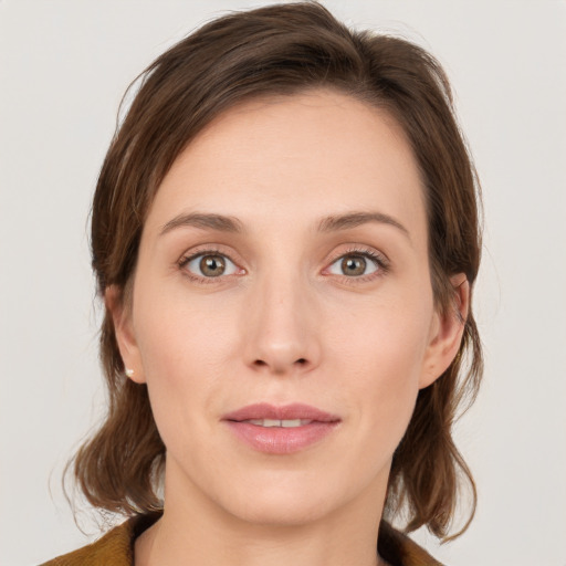 Joyful white young-adult female with medium  brown hair and blue eyes