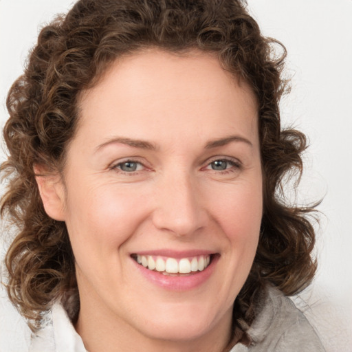 Joyful white young-adult female with medium  brown hair and green eyes