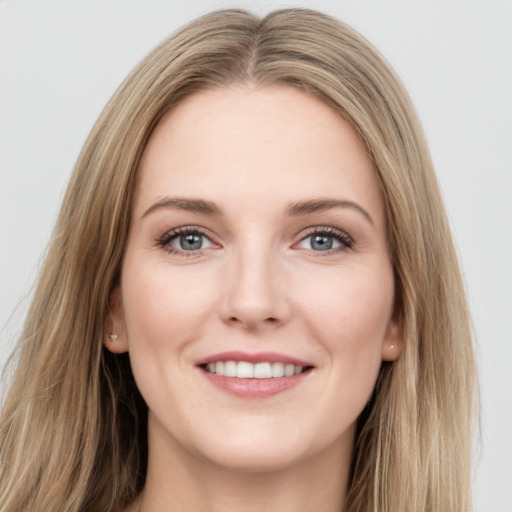 Joyful white young-adult female with long  brown hair and grey eyes