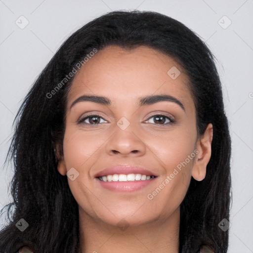 Joyful latino young-adult female with long  black hair and brown eyes