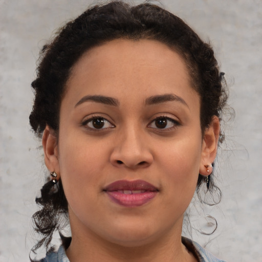 Joyful black young-adult female with medium  brown hair and brown eyes