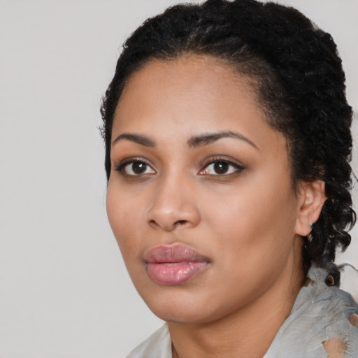 Joyful latino young-adult female with short  black hair and brown eyes