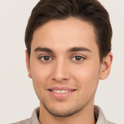 Joyful white young-adult male with short  brown hair and brown eyes