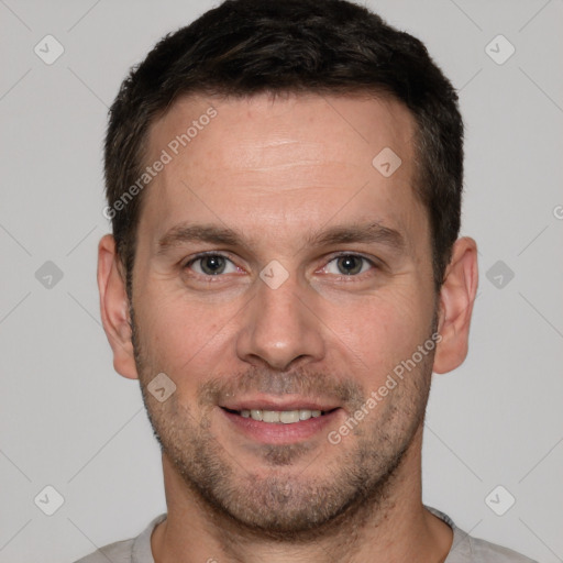 Joyful white adult male with short  brown hair and brown eyes