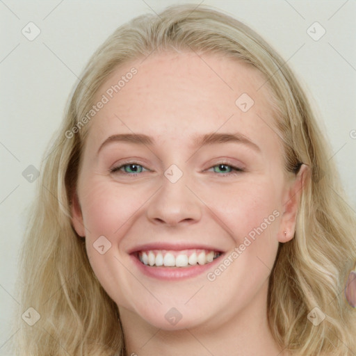 Joyful white young-adult female with long  brown hair and blue eyes