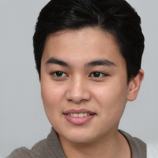 Joyful asian young-adult male with short  brown hair and brown eyes