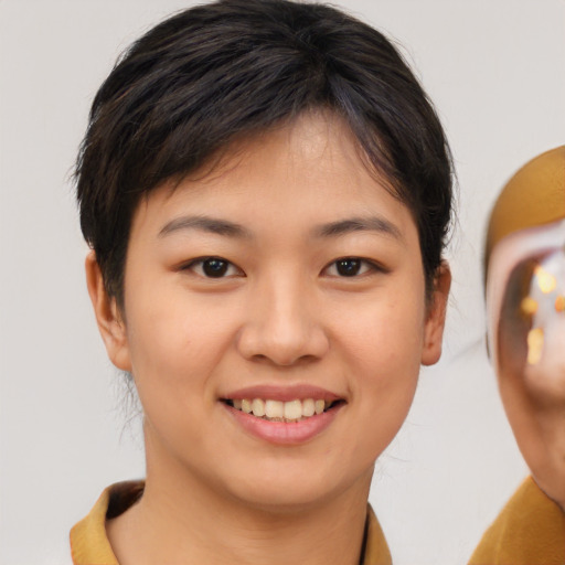 Joyful asian young-adult female with short  brown hair and brown eyes
